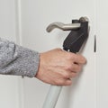 Man secures a door with a blocker bar