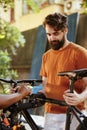 Man securing bicycle on repair-stand