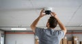 installing a security camera on drop ceiling Royalty Free Stock Photo