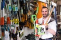 Man selecting gardening equipment in store. Royalty Free Stock Photo