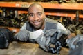 Man selecting second hand car part from shelf