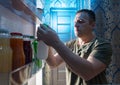 Man selecting something to drink from a fridge Royalty Free Stock Photo