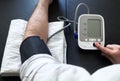 Man self-monitoring of blood pressure with a tensiometer Royalty Free Stock Photo