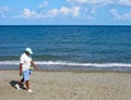 Man - seller of clothespins on beach, Greece