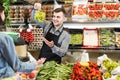 Man seller helping customer to buy fruit Royalty Free Stock Photo