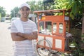 Man selling bakso by walking and pushing down the food carts Royalty Free Stock Photo