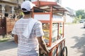 Man selling bakso by walking and pushing down the food carts Royalty Free Stock Photo