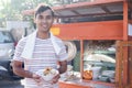 Man selling bakso by walking and pushing down the food carts Royalty Free Stock Photo