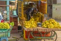 A man selling bananas from a tuk tuk at a local Indian market