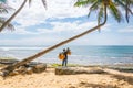 A man selling coconuts and pineapples on the beach, Hikkaduwa, Sri Lank