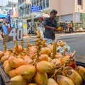 Man selling coconuts on the street in town