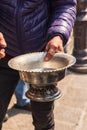 Man selling copper and tin ware at a market in Srinagar