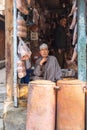 Man selling copper and tin ware at a market in Srinagar