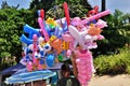 Man selling cotton candy and inflatable toys by the beach