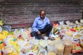 A man selling dried foods on street in Delhi, India