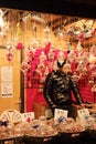 a man is selling gifts at an indoor christmas market area