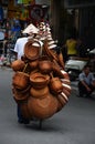 Man selling hats and baskets on a bicycle in Hanoi city