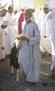 Man selling his goat at a market in Nizwa