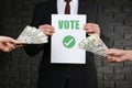 Man selling his vote on dark background. Corruption concept