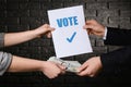 Man selling his vote on dark background. Corruption concept Royalty Free Stock Photo