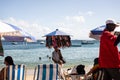 Man selling sunscreen walks on beach