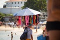 Man selling sunscreen walks on beach