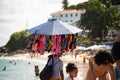 Man selling swimsuits walking on Porto da Barra beach