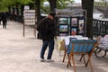 Man sellling his paintings on the riverbank in Prague, Czech Republic