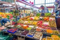 man sells fresh vegetables and fruits in the Kleinmarkthalle - engl: small markethall - in Frankfurt Royalty Free Stock Photo