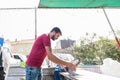 man sells live pigeons kept at cage at Pigeon Bazaar