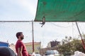 man sells live pigeons kept at cage at Pigeon Bazaar