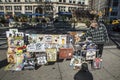 Man sells replika of old vintage enamel advertising plates to tourists