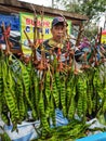 A man sells stinky beans at the morning market.
