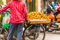 A man sells tangerines in the local market in Hanoi, Vietnam. Close-up.