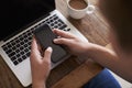 Man Sending Text Message On Mobile Phone Whilst Using Laptop Royalty Free Stock Photo