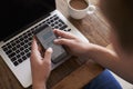 Man Sending Text Message On Mobile Phone Whilst Using Laptop Royalty Free Stock Photo