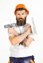 Man with serious face holds putty knife and plastering tool. Royalty Free Stock Photo