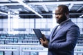 Man in server hub optimizing data center equipment with device Royalty Free Stock Photo