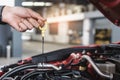 Man service mechanic maintenance inspection service maintenance car Check engine oil level car in garage showroom dealership Royalty Free Stock Photo