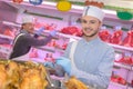 Man serving cooked chickens