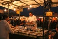 Man serving cooked snails at stall