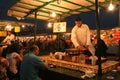 Man serving cooked snails at stall