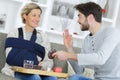 Man serving meal to injured woman Royalty Free Stock Photo