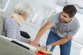 man serving meal to injured woman Royalty Free Stock Photo