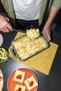 Man serving pasta with a spoon