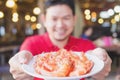 Man is serving steamed shrimp in a white plate Royalty Free Stock Photo