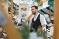 Man serving street food on international cuisine event in Ljubljana, Slovenia.