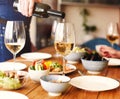 Man serving wine during dinner Royalty Free Stock Photo