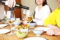 Man serving wine during dinner Royalty Free Stock Photo