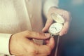 Man set a pocket watch clock in the time change vintage colored photo. Royalty Free Stock Photo